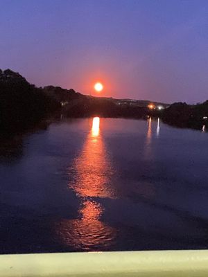 the sun is setting over a body of water
