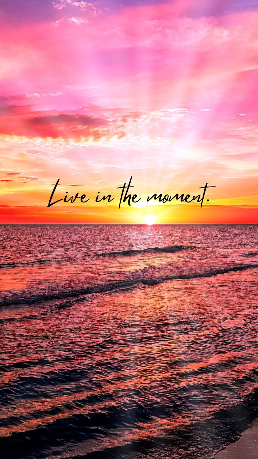 a sunset with the words live in the moment