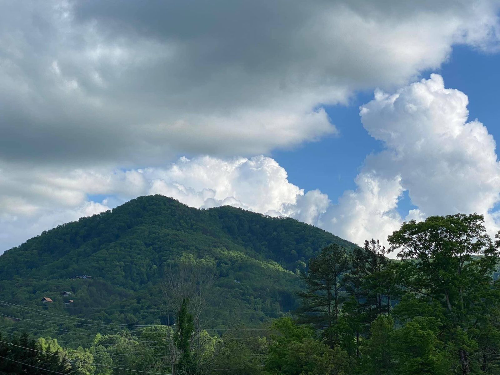 a view of a mountain with clouds in the sky