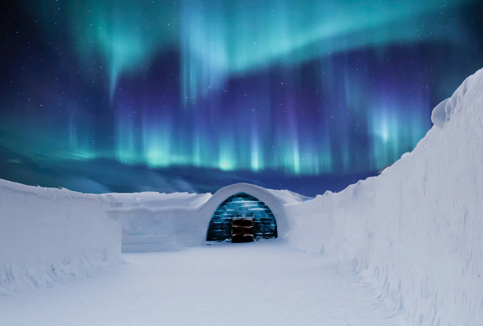 an igloose with the aurora lights in the background