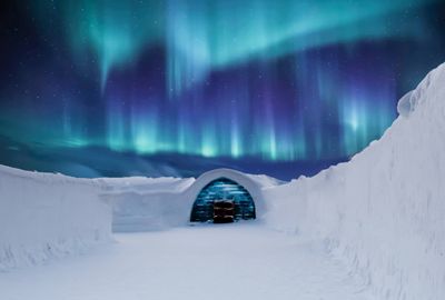 an igloose with the aurora lights in the background