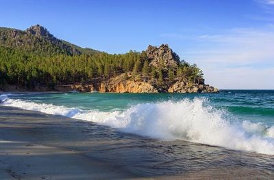a large body of water sitting next to a forest