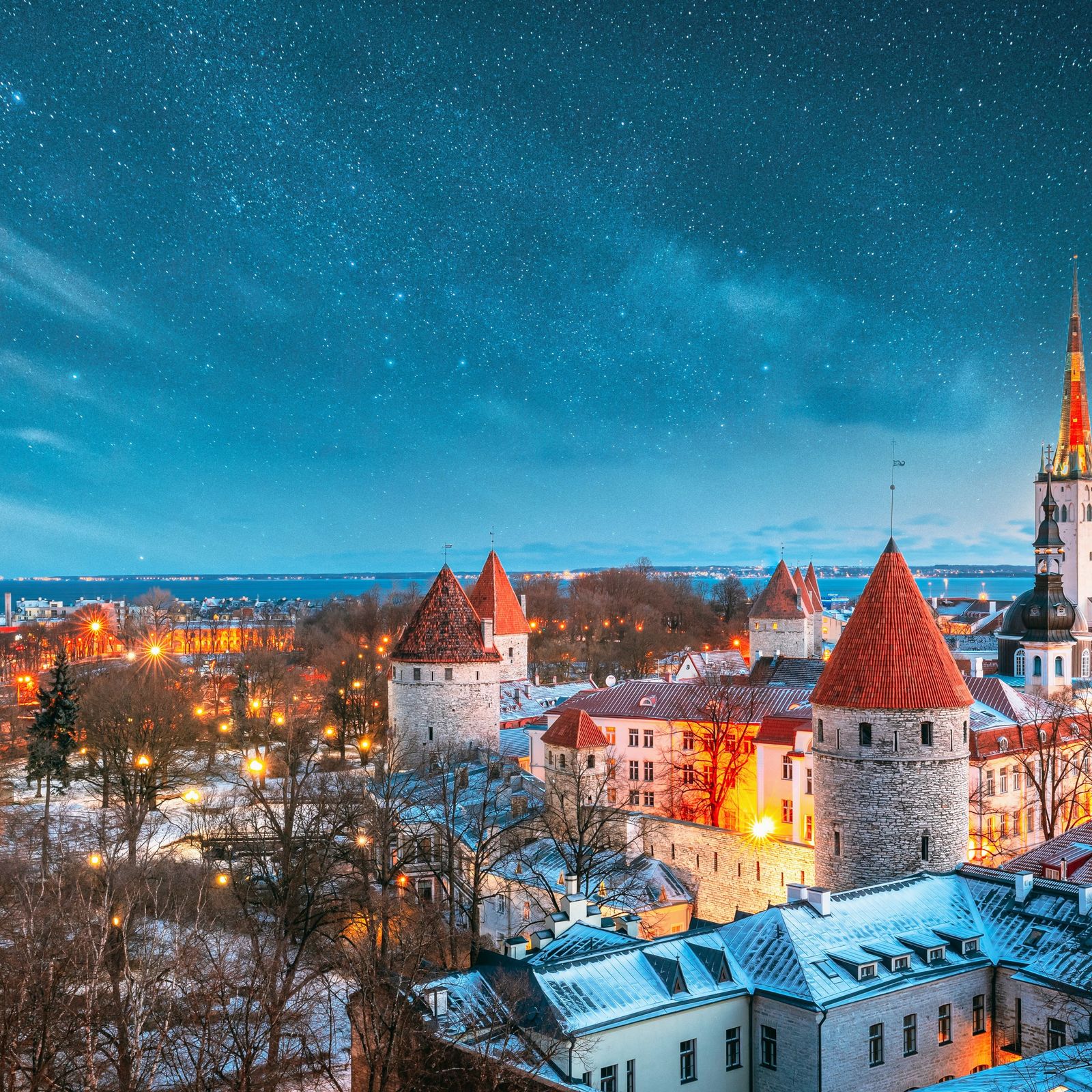 a view of a city at night with stars in the sky
