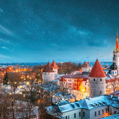 a view of a city at night with stars in the sky