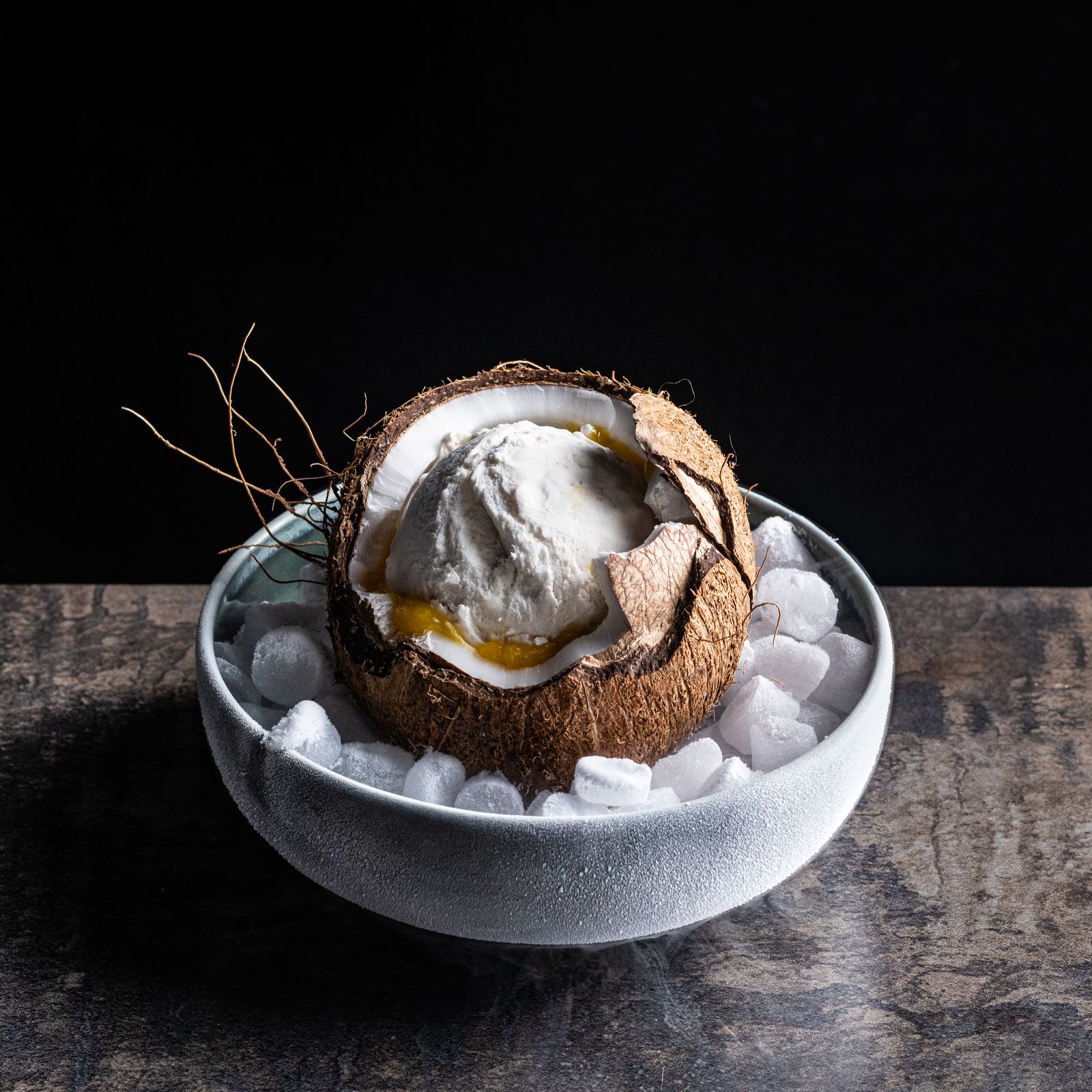 a bowl filled with ice cream and a coconut