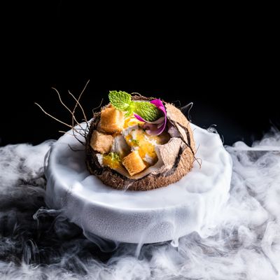 a white plate topped with food on top of smoke