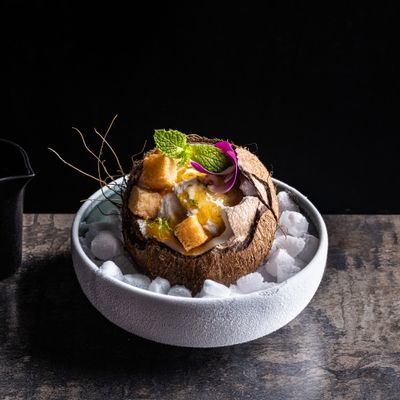 a bowl of food on a wooden table