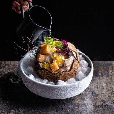 a bowl of food on a wooden table