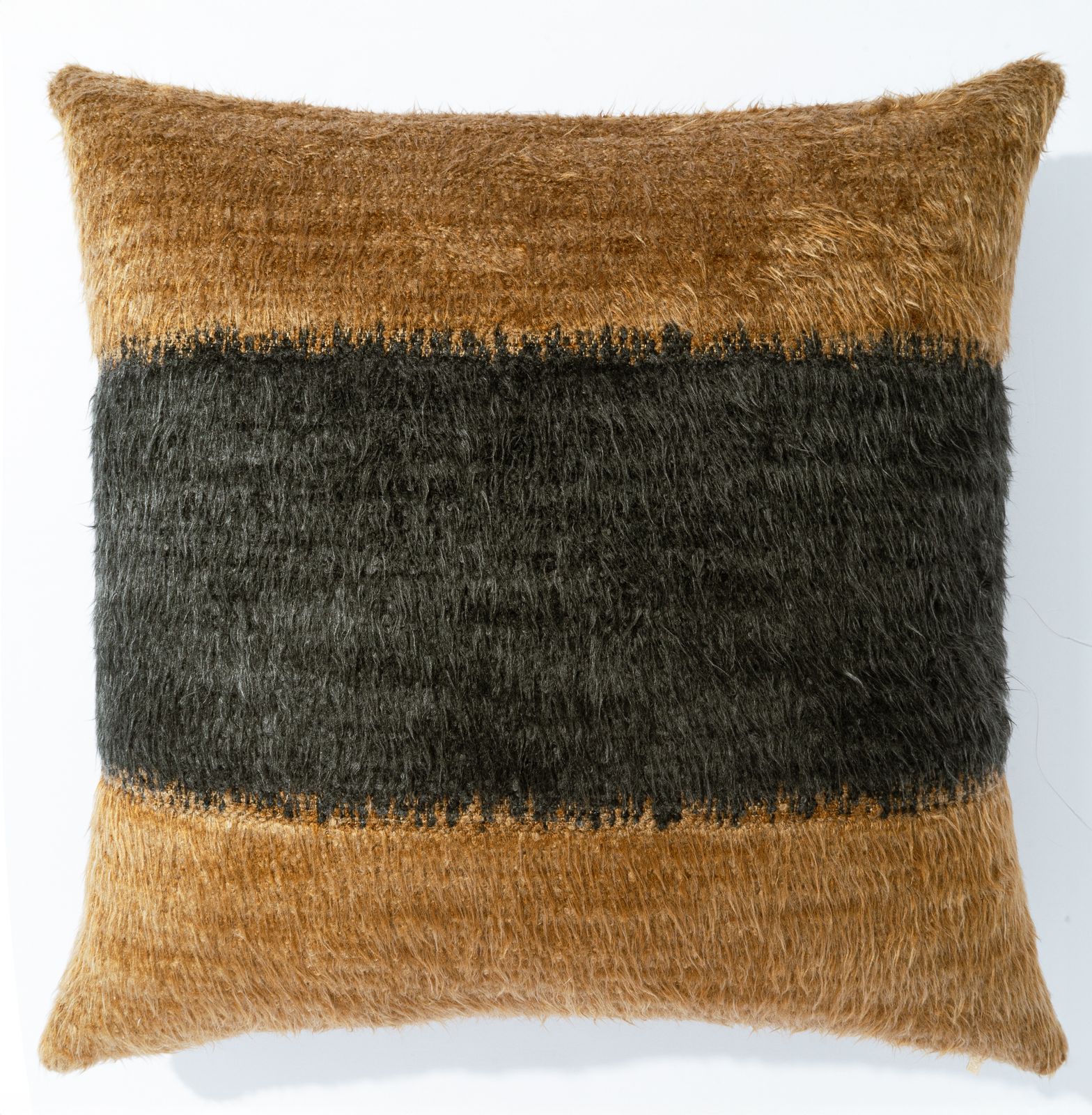 a brown and black pillow on a white wall