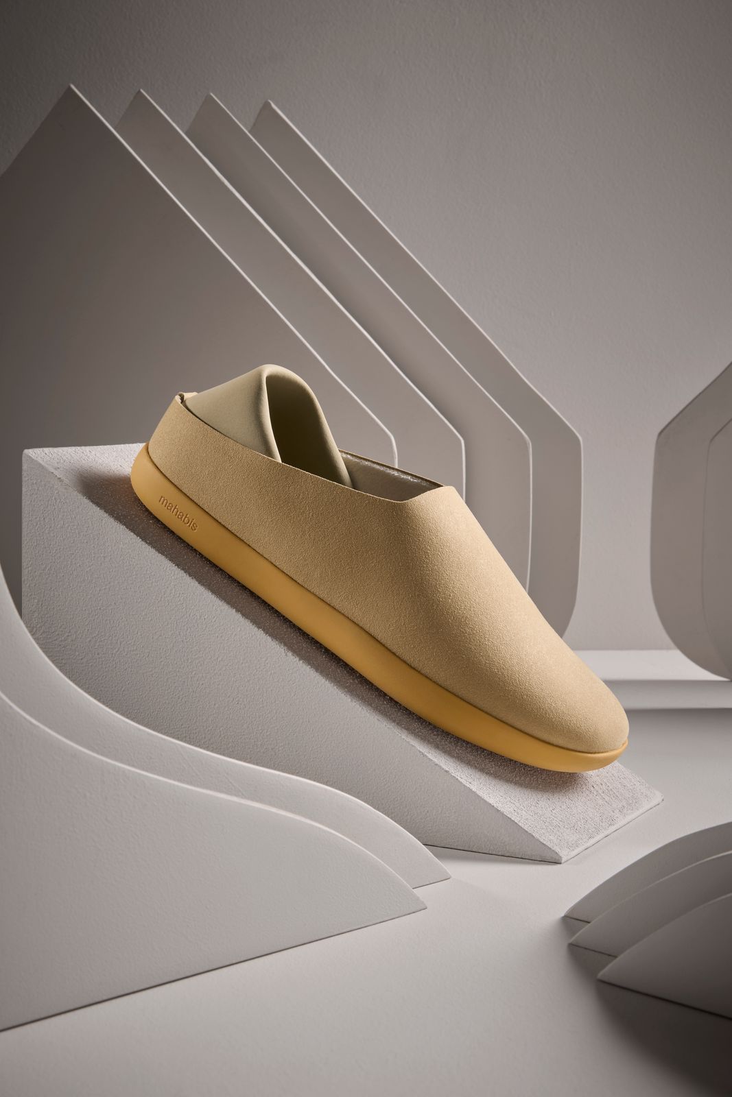 a pair of shoes sitting on top of a white surface