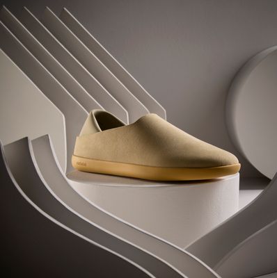 a pair of shoes sitting on top of a white shelf