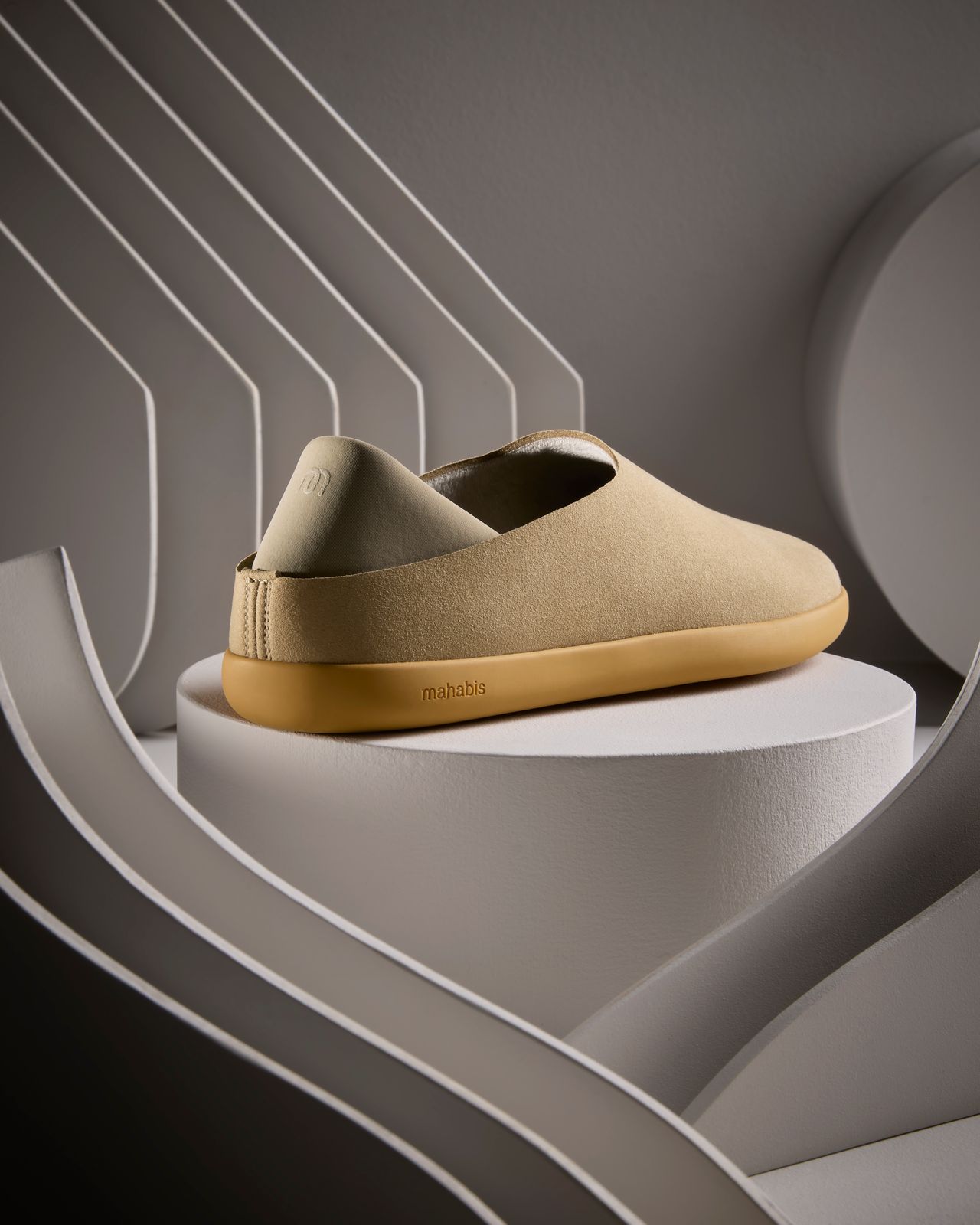 a pair of shoes sitting on top of a white pedestal