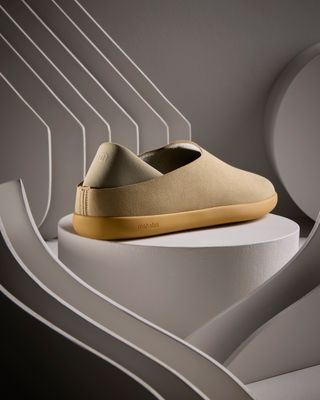 a pair of shoes sitting on top of a white pedestal