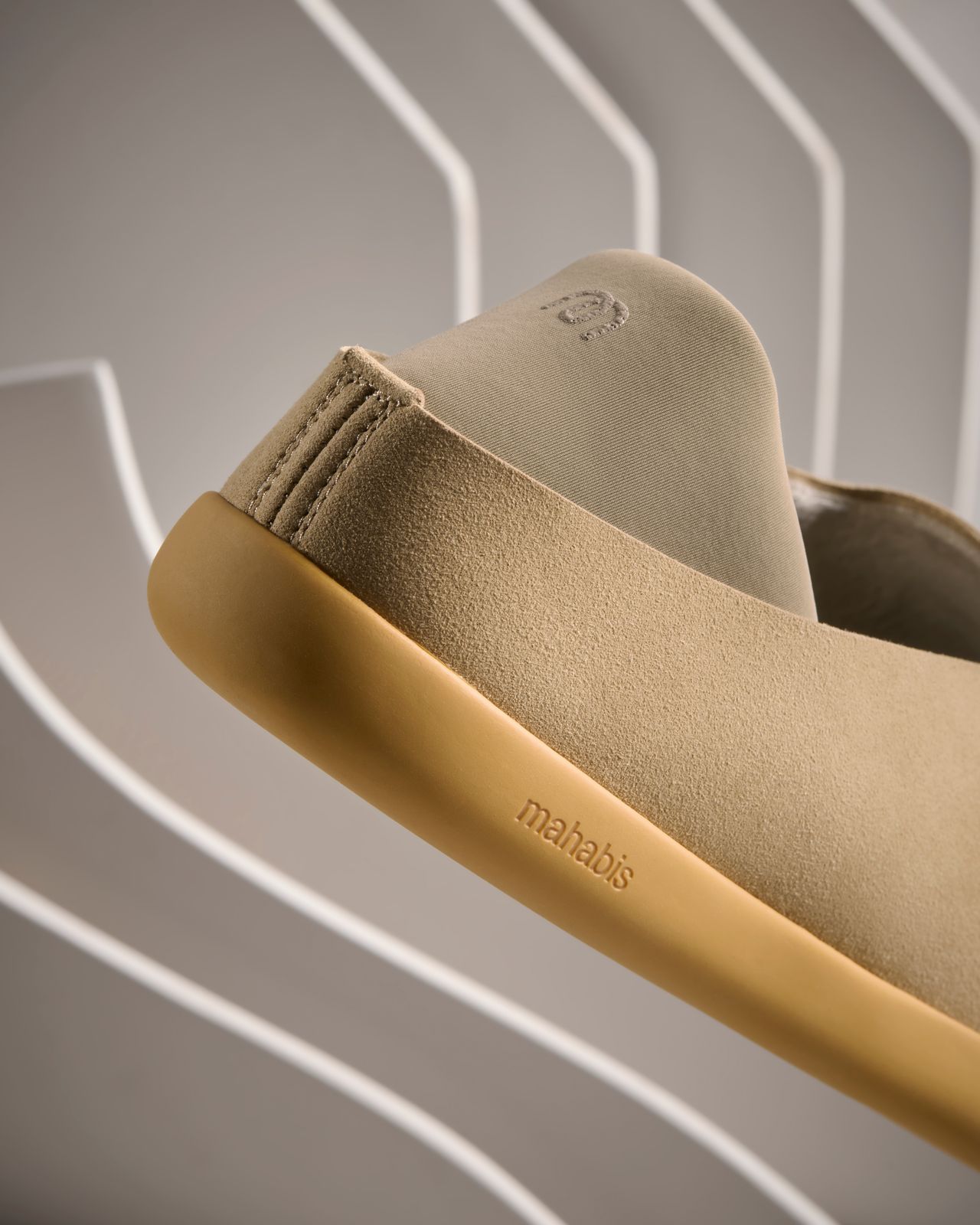 a pair of beige shoes hanging from a hook