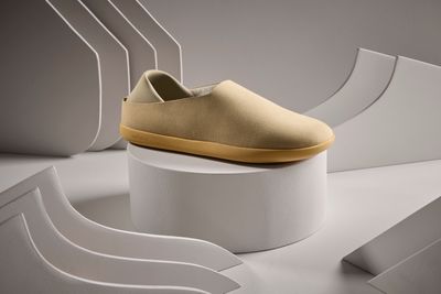 a pair of shoes sitting on top of a white pedestal