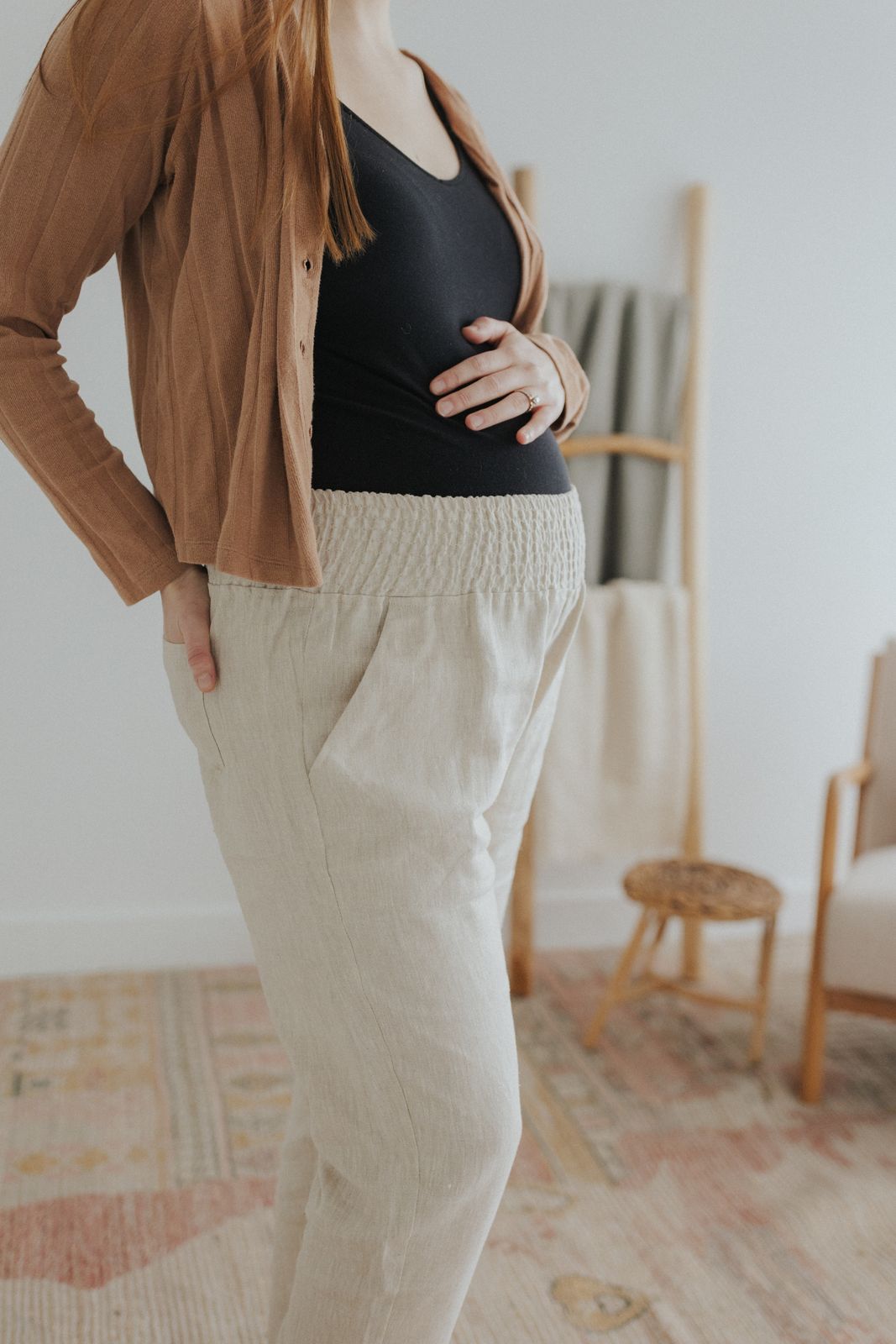 a woman standing in a room with her hands on her hips