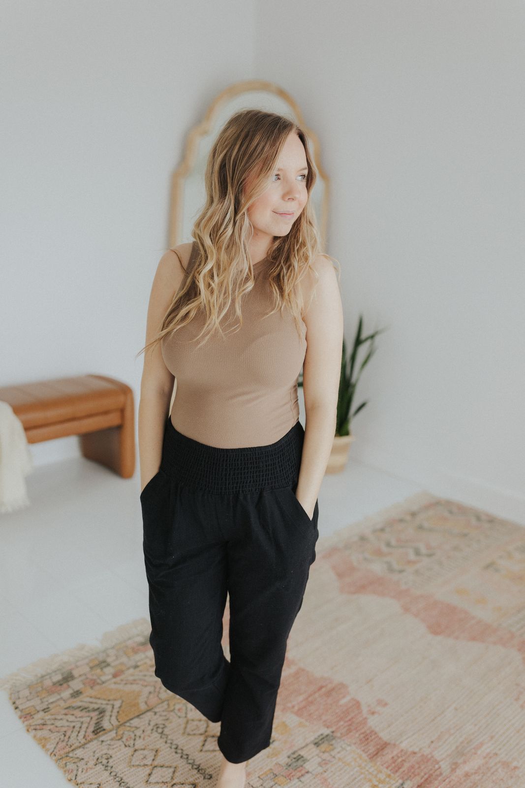 a woman standing on a rug in a room
