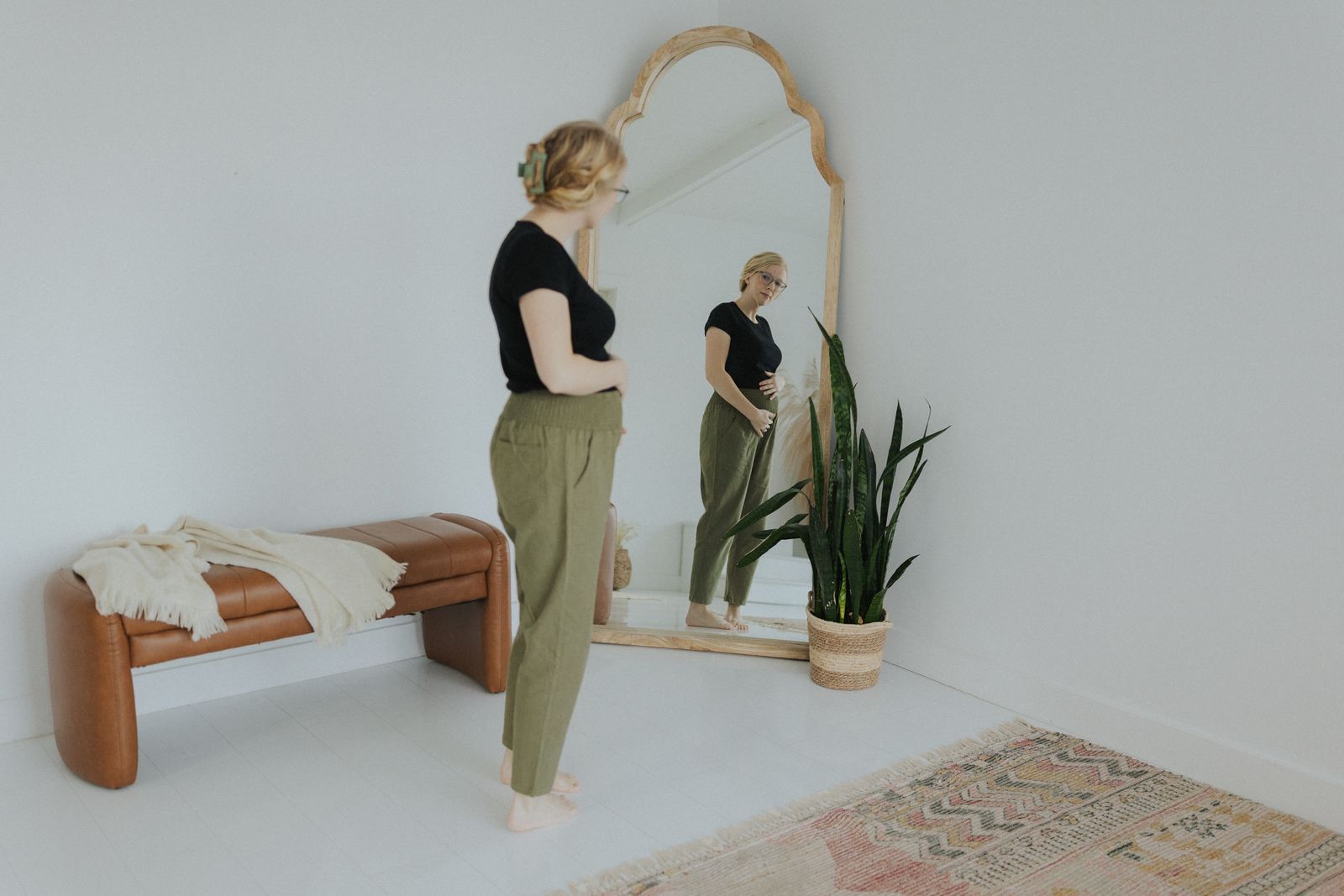 a woman standing in front of a mirror