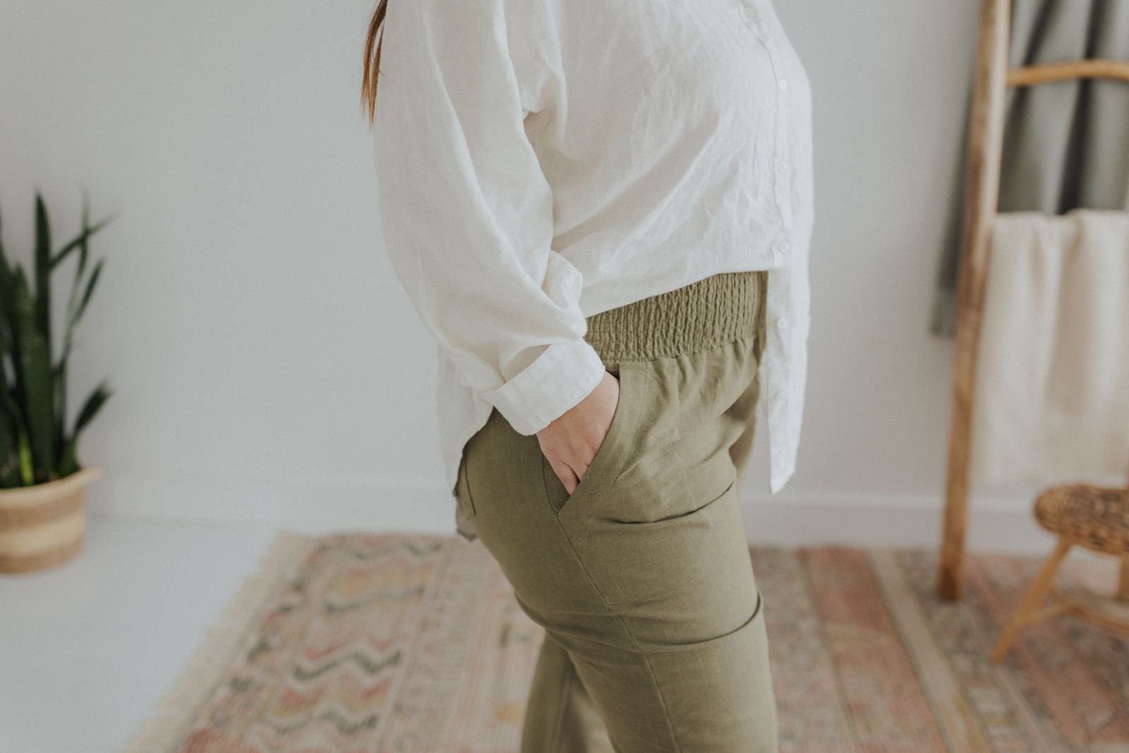 a woman in a white shirt and khaki pants