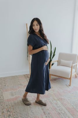 a pregnant woman standing in a living room