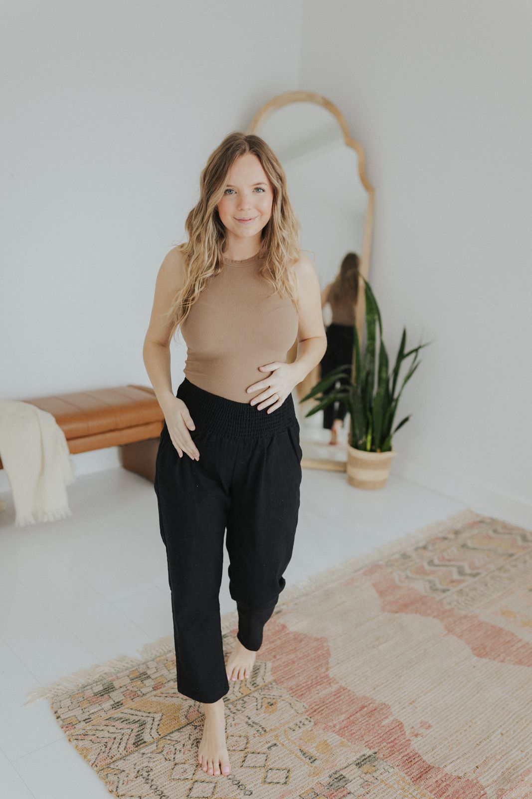 a woman standing in front of a mirror