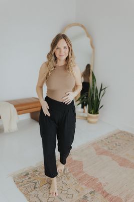 a woman standing in front of a mirror