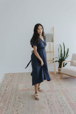 a woman standing on a rug in a room