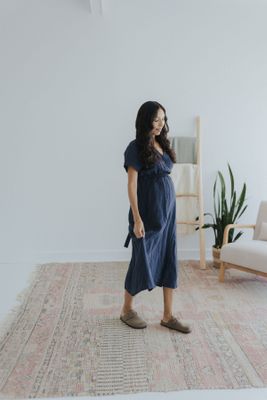 a woman standing on a rug in a room