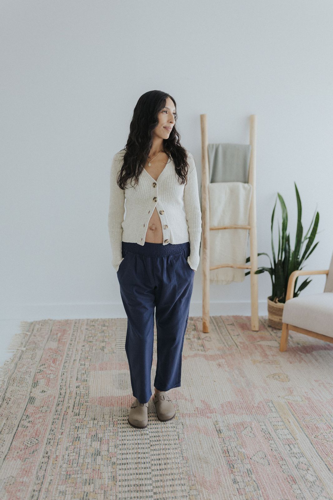 a woman standing on a rug in a room