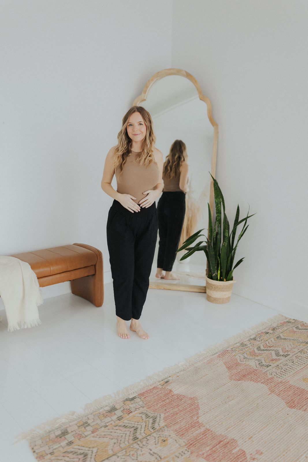 a woman standing in front of a mirror