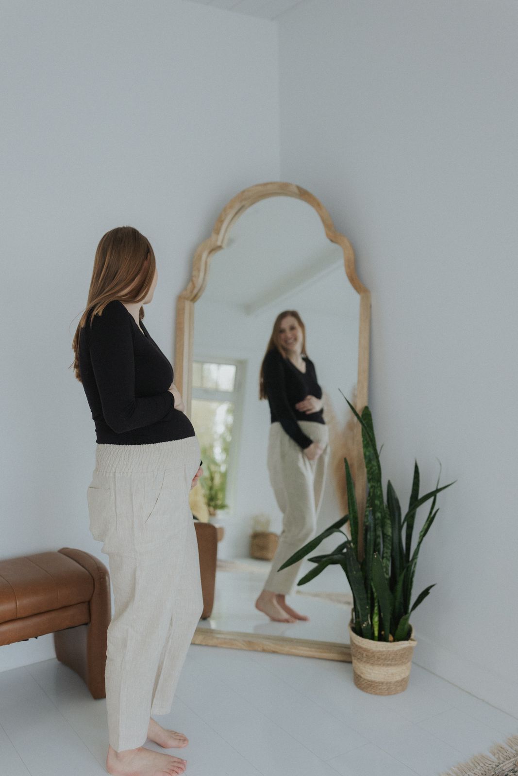 a woman standing in front of a mirror
