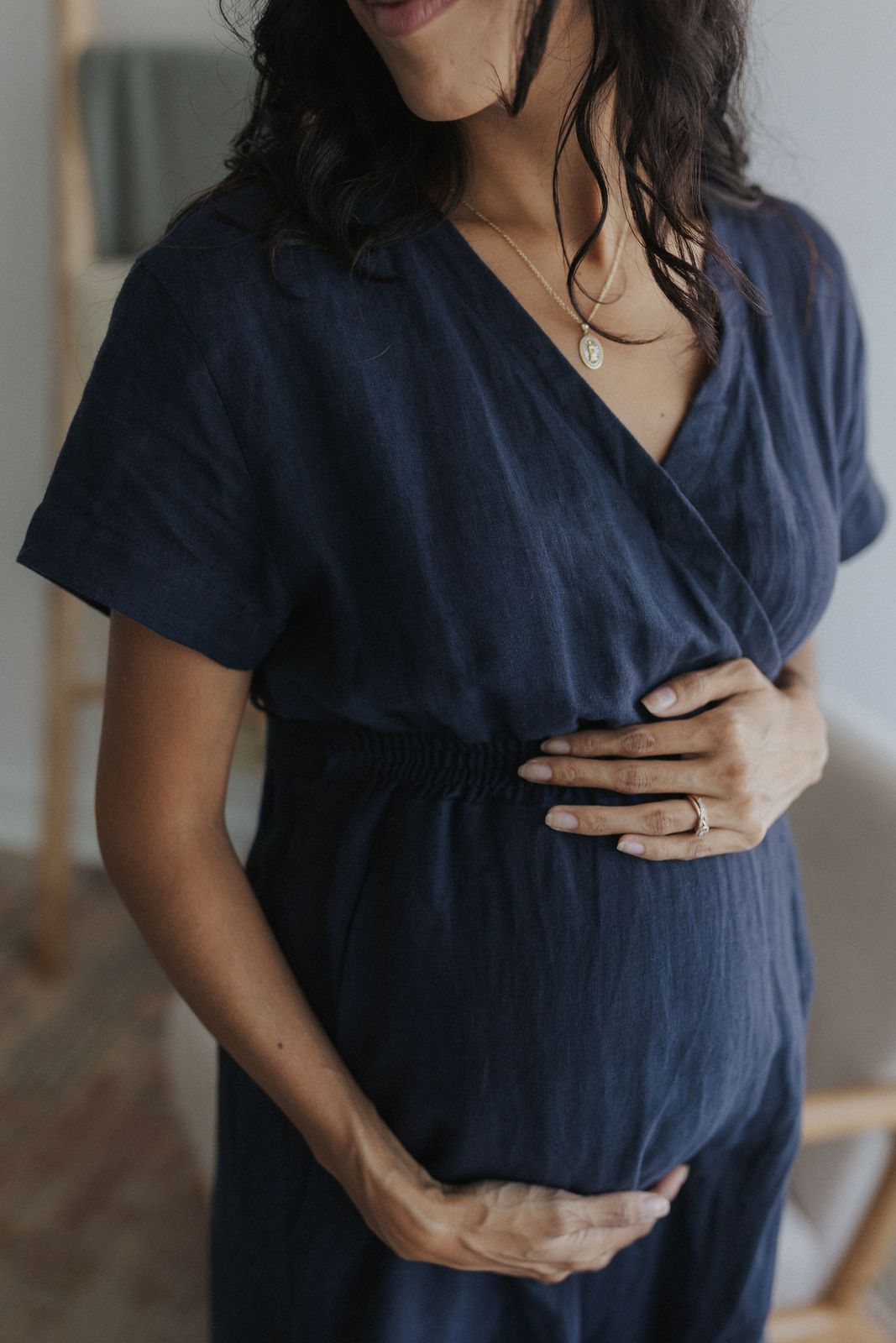 a pregnant woman wearing a blue dress