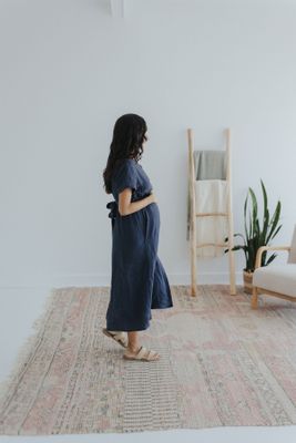 a woman standing on a rug in a room