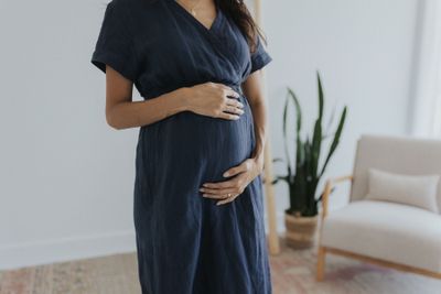 a pregnant woman standing in a living room