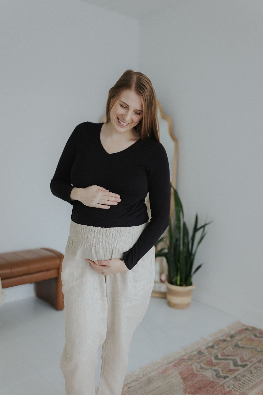 a woman standing in a room with her stomach exposed