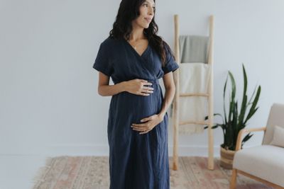 a pregnant woman standing in a living room
