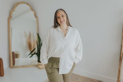 a woman standing in front of a mirror