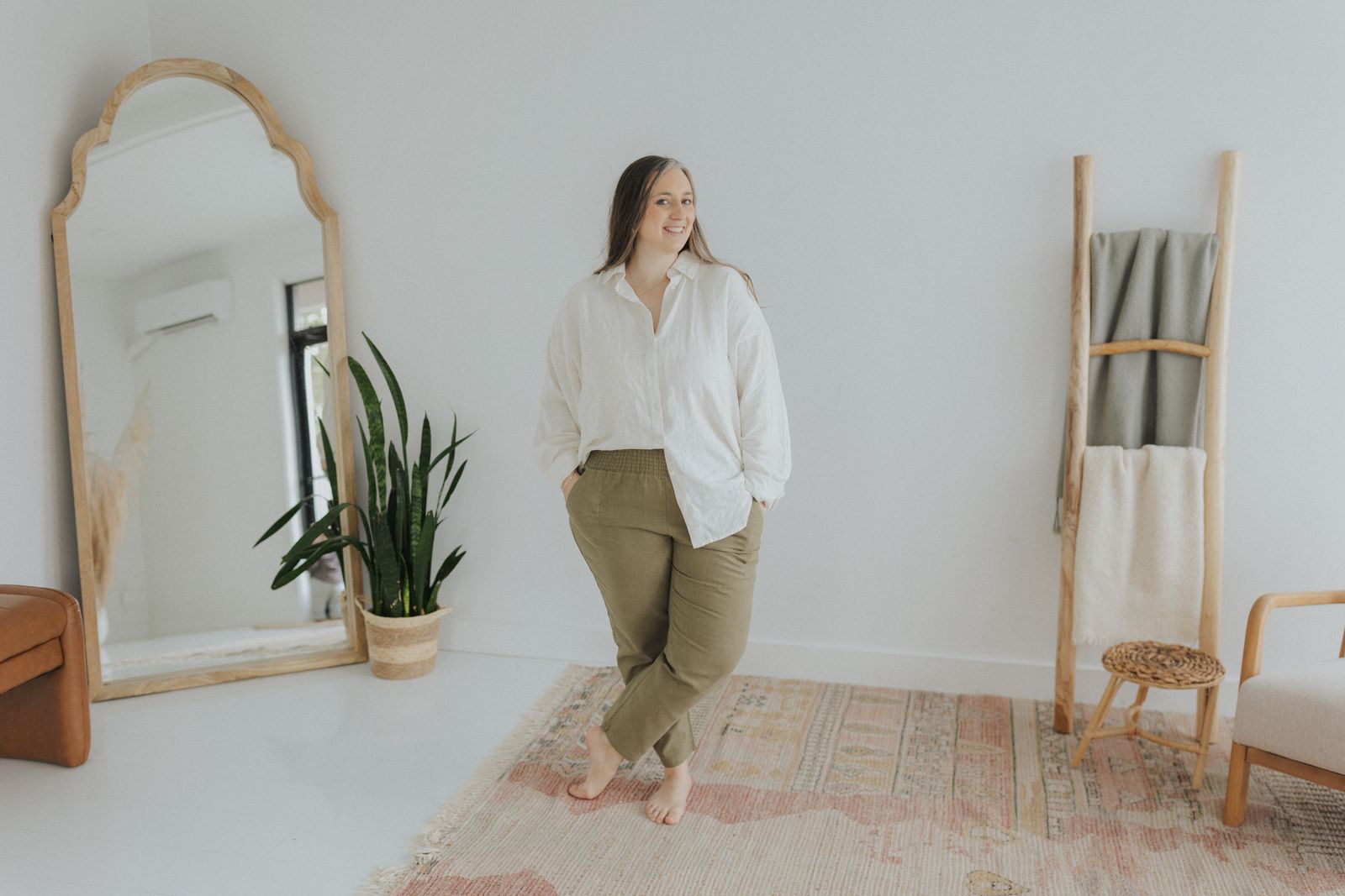 a woman standing in front of a mirror in a room