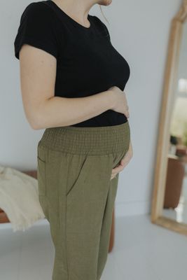 a woman in a black shirt and khaki pants