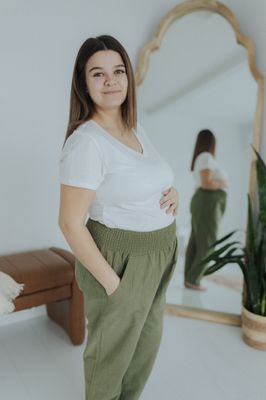 a woman standing in front of a mirror