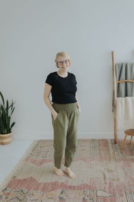 a woman standing on a rug in a room