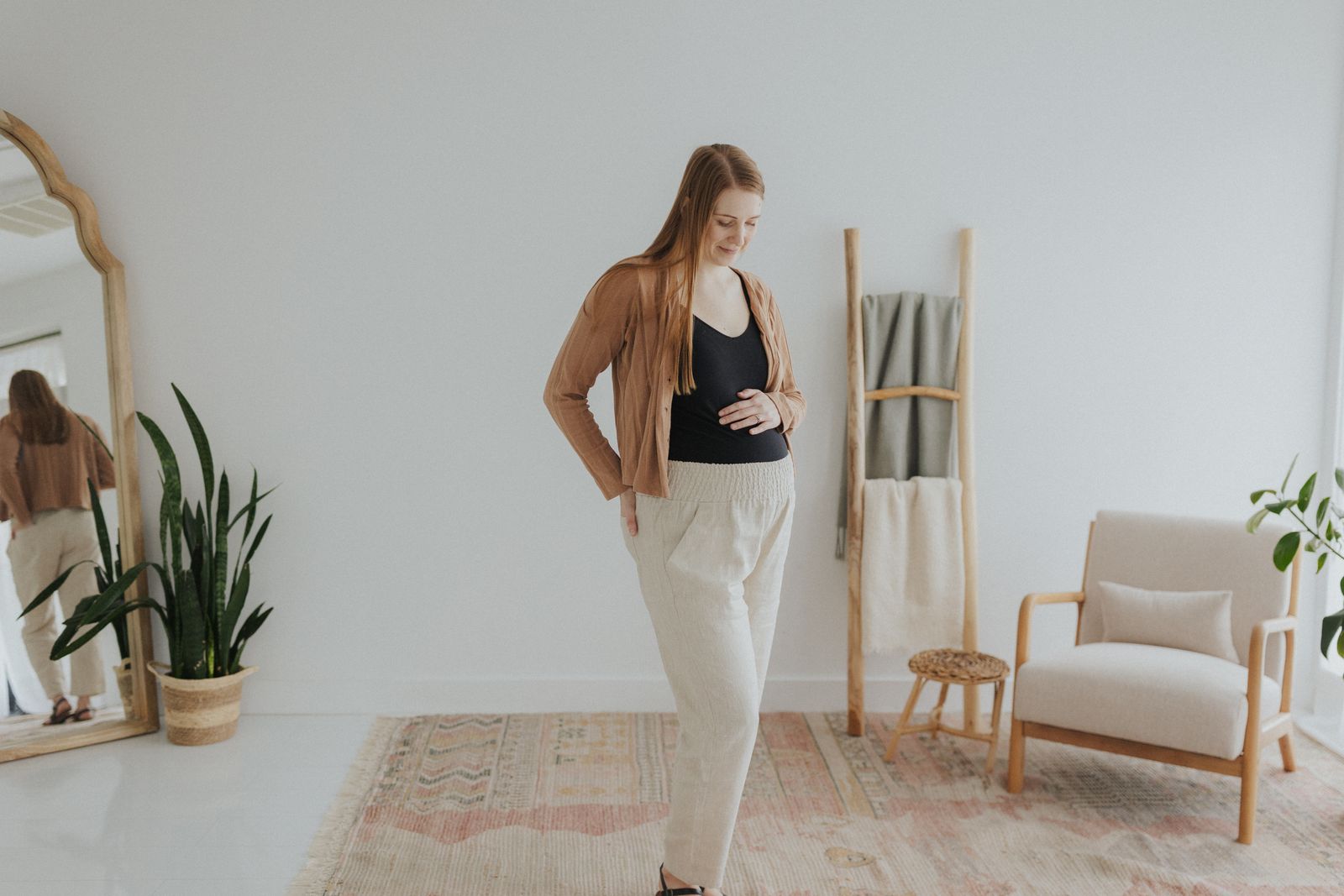 a woman standing in front of a mirror in a room