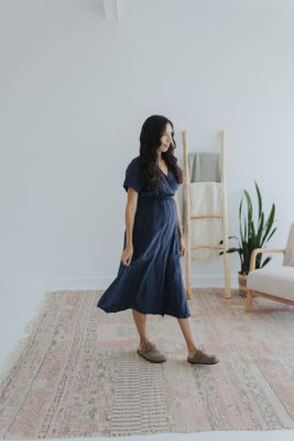 a woman standing on a rug in a room