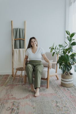a woman sitting on a chair in a room