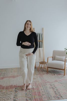 a woman standing on a rug in a room