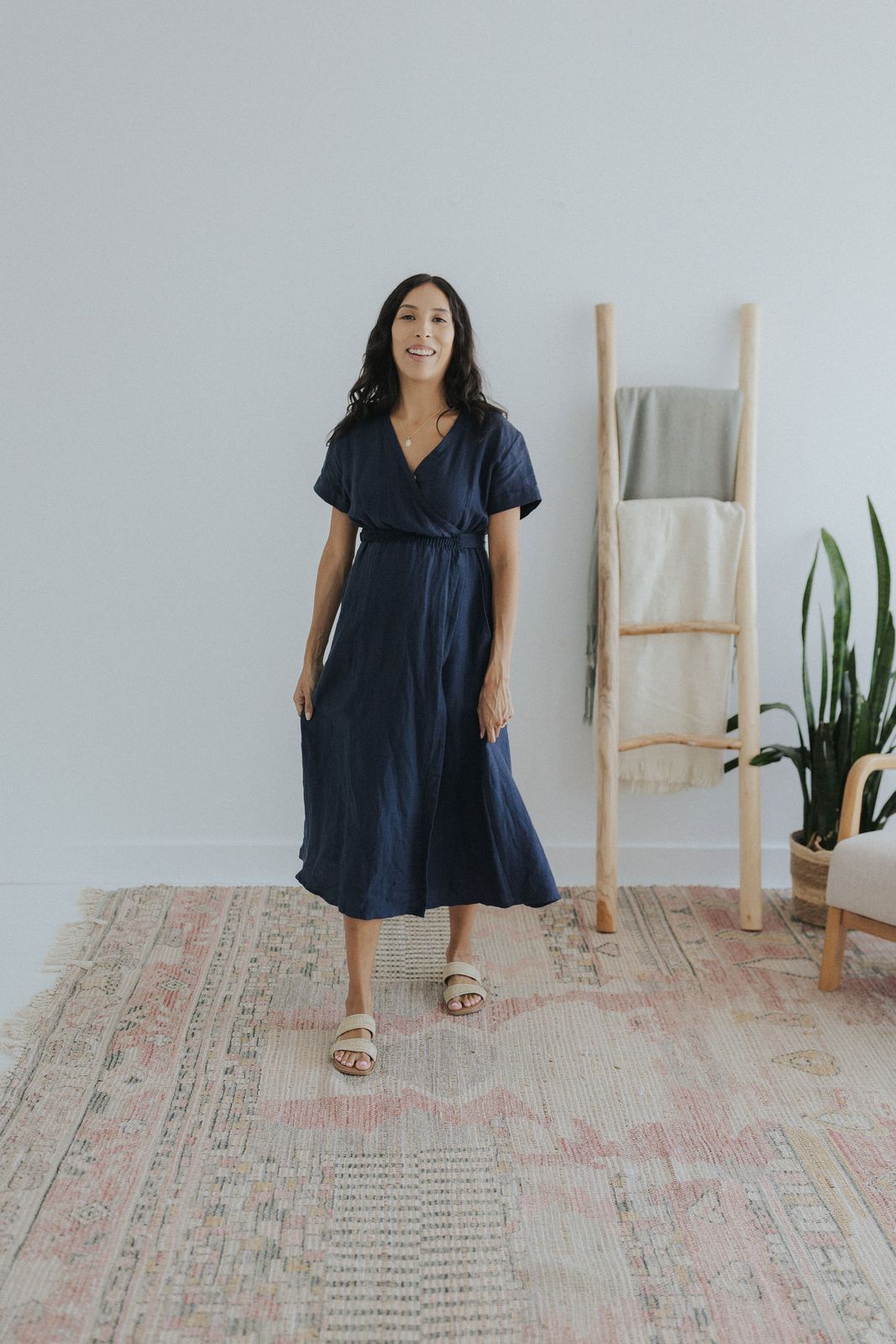 a woman standing on a rug in a room