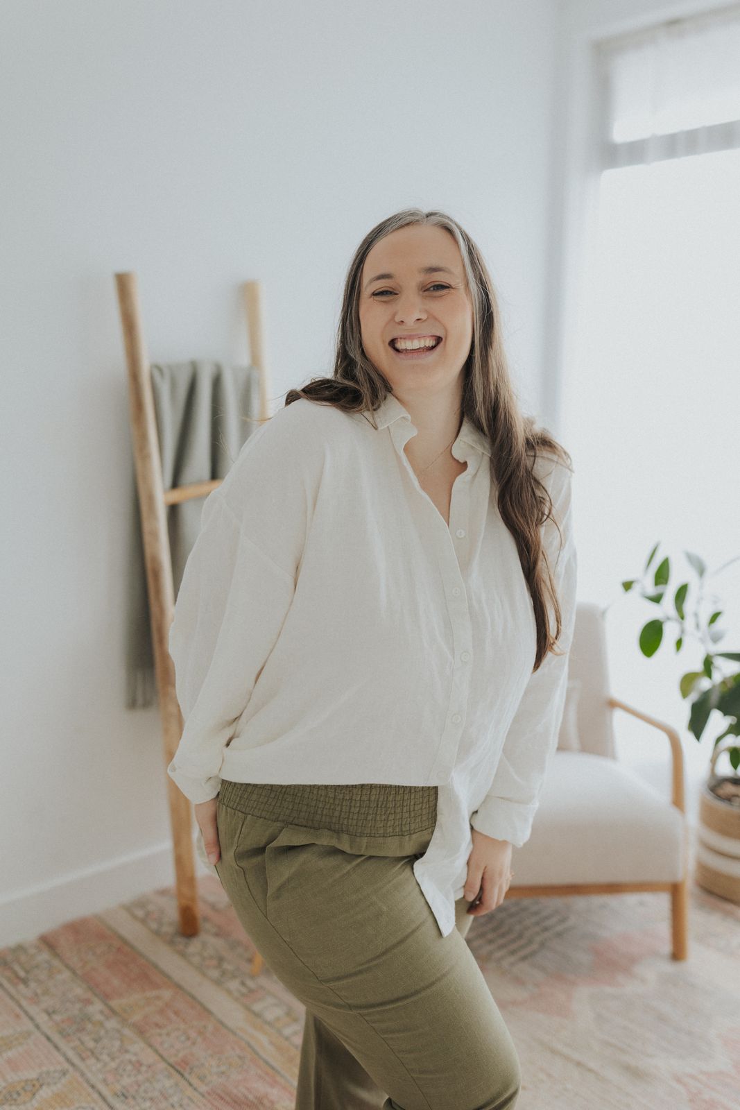 a woman in a white shirt and khaki pants