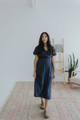 a woman standing on a rug in a room