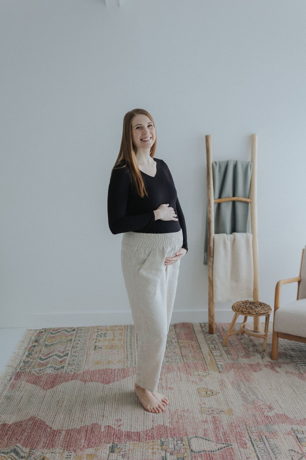 a woman standing in front of a white wall