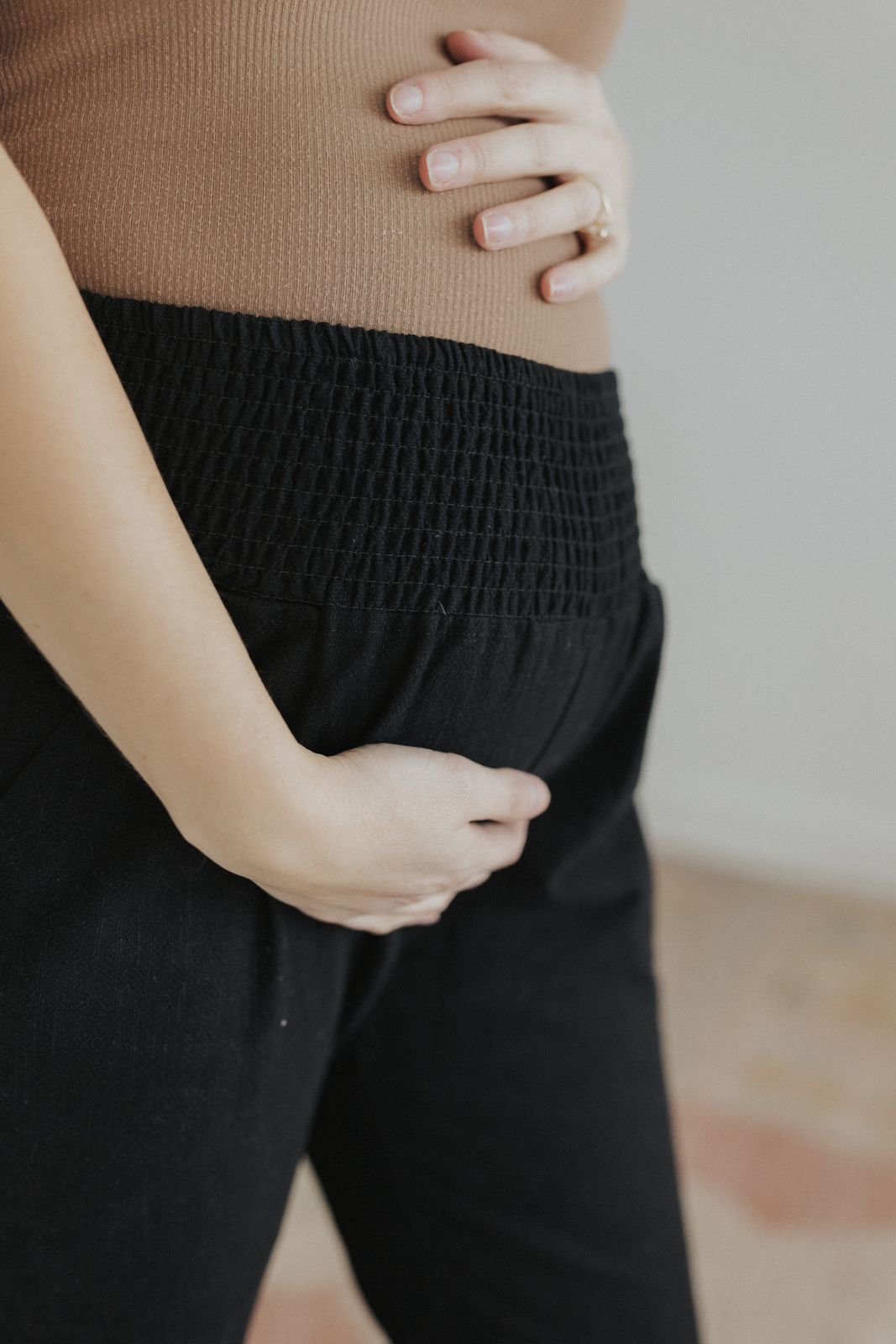 a close up of a person wearing black pants